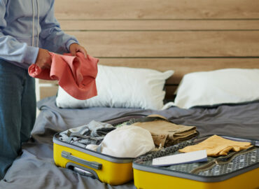 Student Packing Suitcase Cropped image of college girl packing suitcase to leave for university
